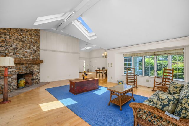 a living room with furniture fireplace and window