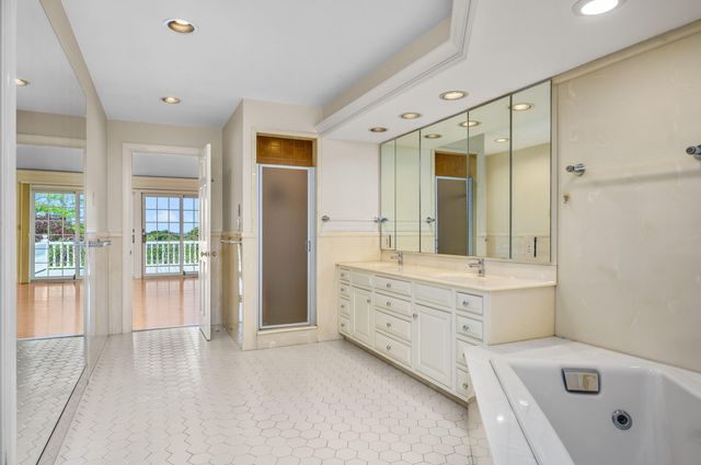 a bathroom with a double vanity sink mirror and shower