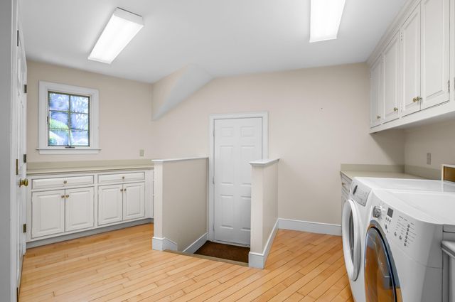 a view of empty room with wooden floor and window