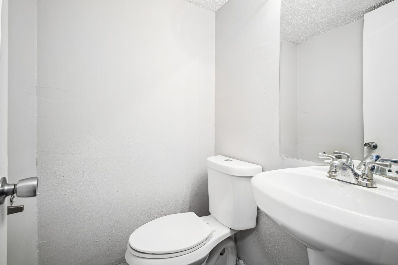 a white toilet sitting next to a bathroom sink