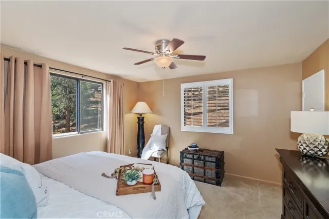 a bedroom with a bed and two lamp