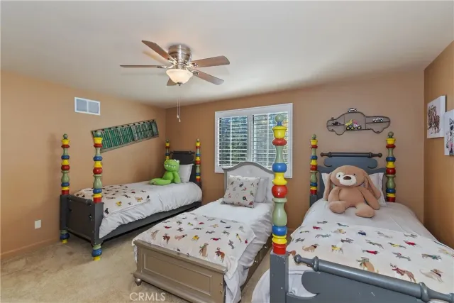 a bedroom with two beds and a window