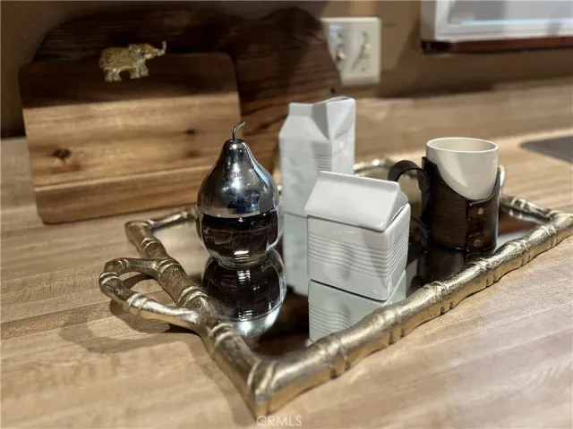 a kitchen with stainless steel appliances granite countertop a refrigerator a sink dishwasher a stove and a dining table with wooden floor