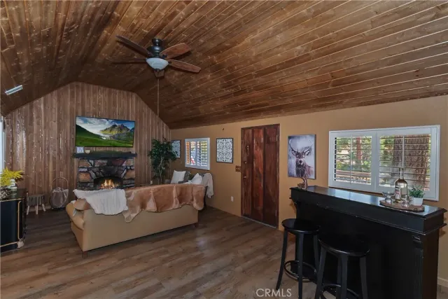 a living room with furniture and potted plants