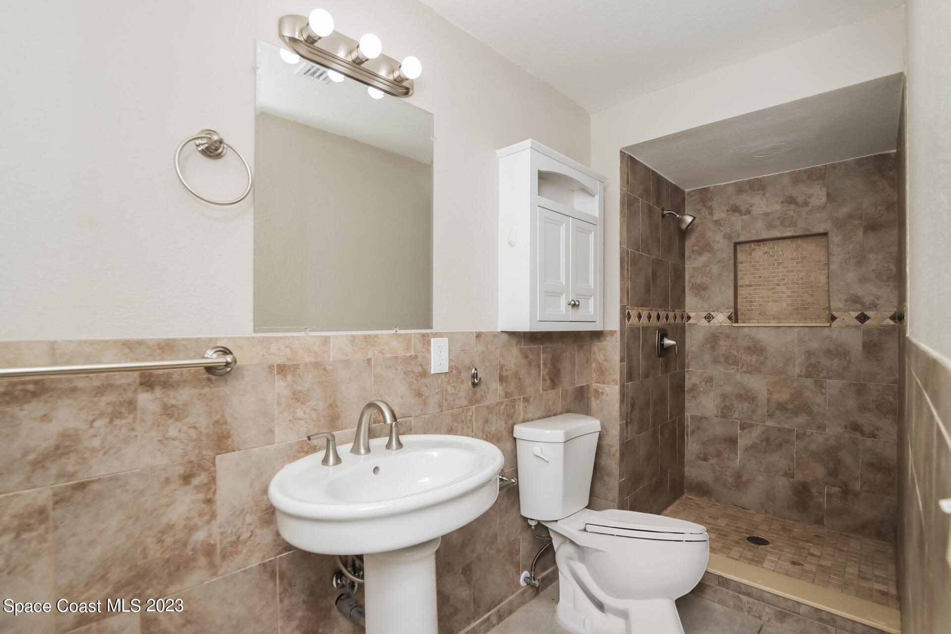 2389 Ricky Road Melbourne, FL 32935 - Photo 13 of 16 a bathroom with a sink a toilet and shower