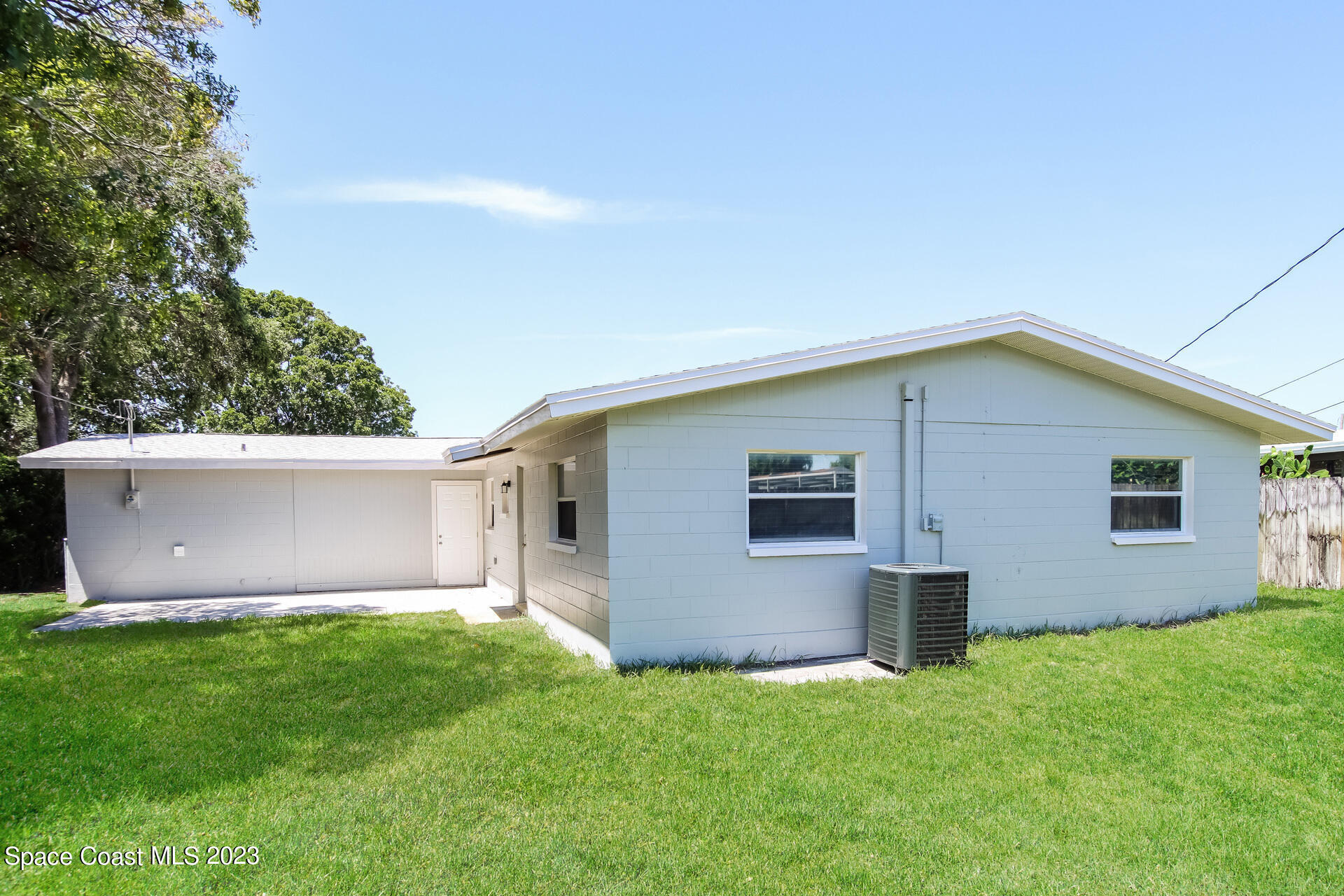 2389 Ricky Road Melbourne, FL 32935 - Photo 14 of 16 a front view of house with yard and garage