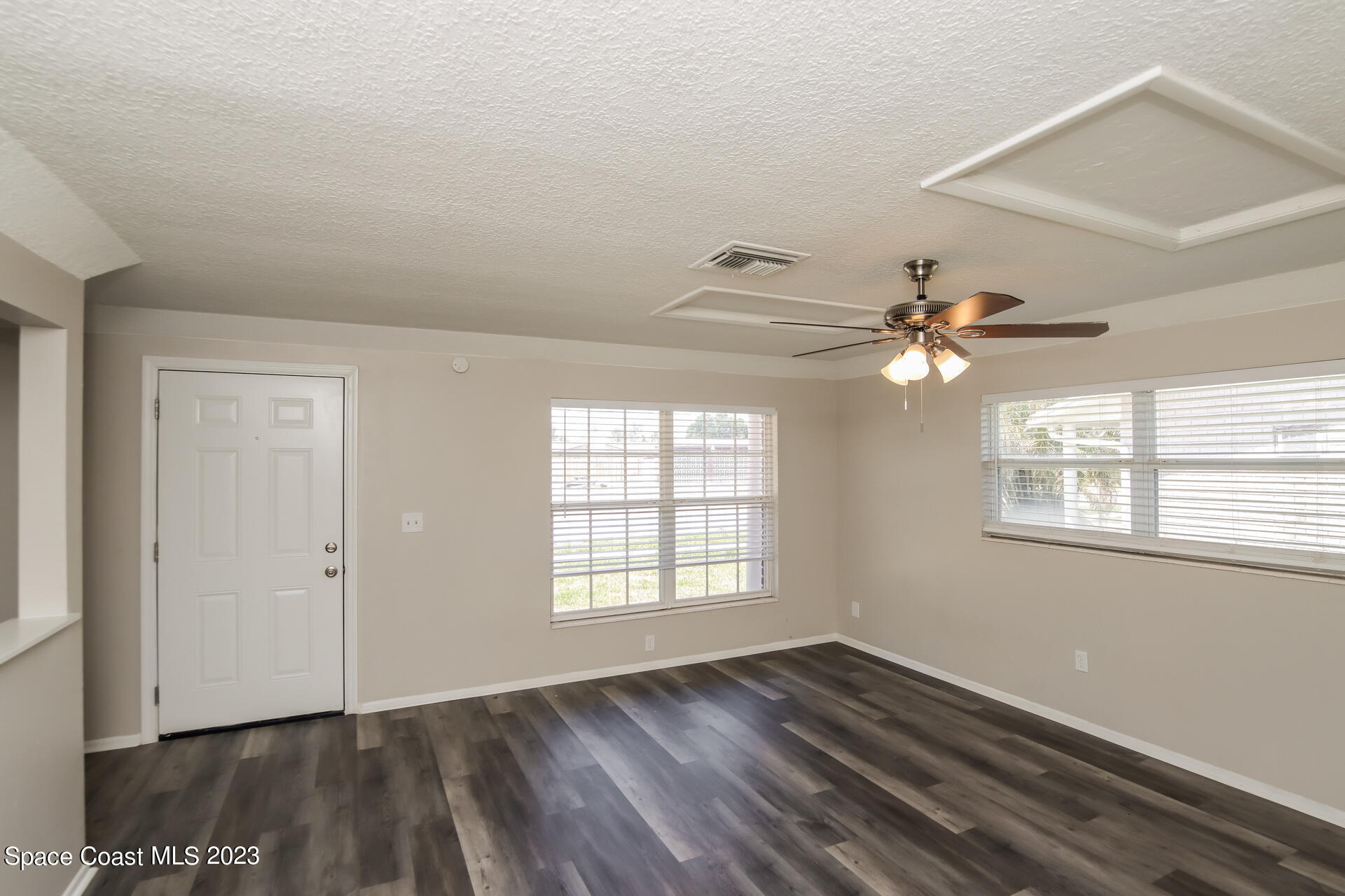 2389 Ricky Road Melbourne, FL 32935 - Photo 3 of 16 wooden floor in an empty room with a window