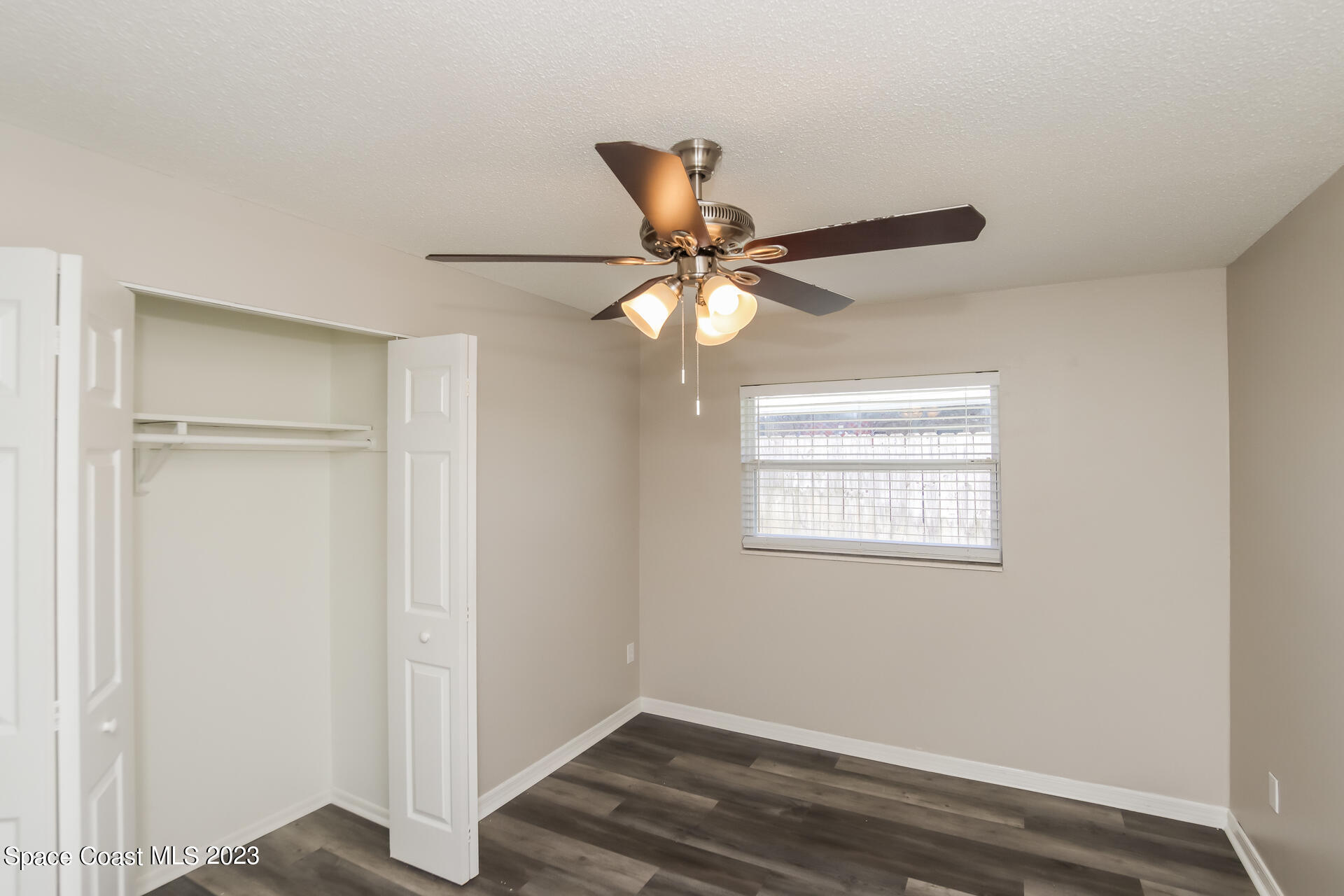 2389 Ricky Road Melbourne, FL 32935 - Photo 10 of 16 a view of room with window and wooden floor