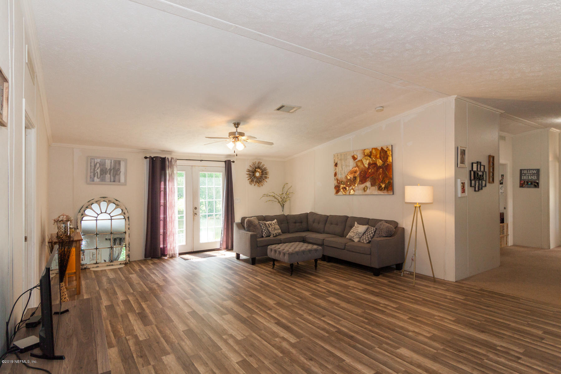 55154 Spencerville Road Callahan, FL 32011 - Photo 1 of 23 a living room with furniture and a wooden floor