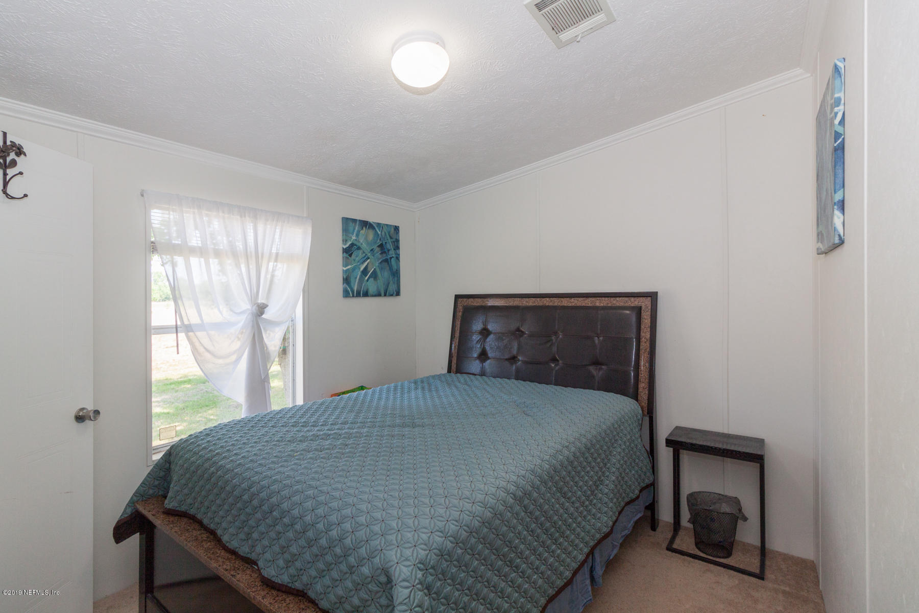 55154 Spencerville Road Callahan, FL 32011 - Photo 15 of 23 a bedroom with a bed and window