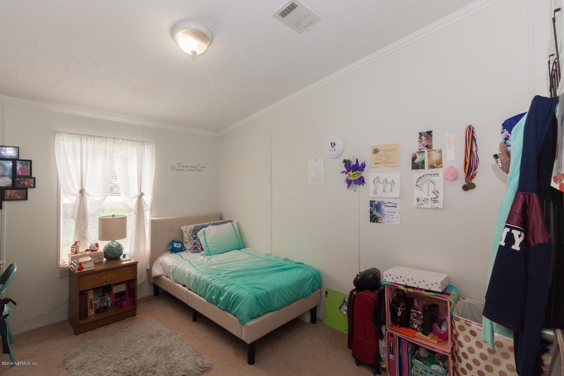 55154 Spencerville Road Callahan, FL 32011 - Photo 17 of 23 a bedroom with a bed and a window