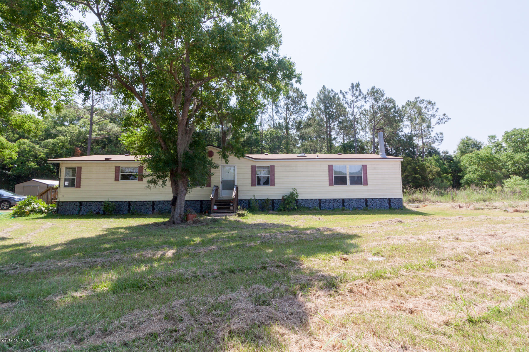 55154 Spencerville Road Callahan, FL 32011 - Photo 23 of 23 a view of a house with a yard