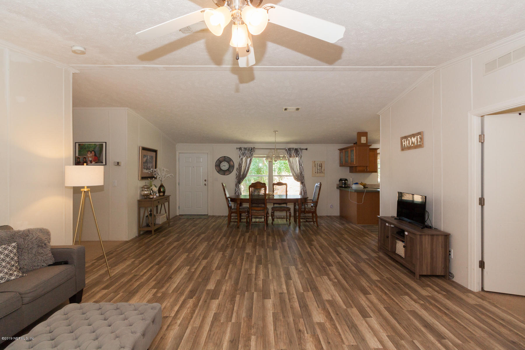 55154 Spencerville Road Callahan, FL 32011 - Photo 6 of 23 a living room with furniture and a chandelier