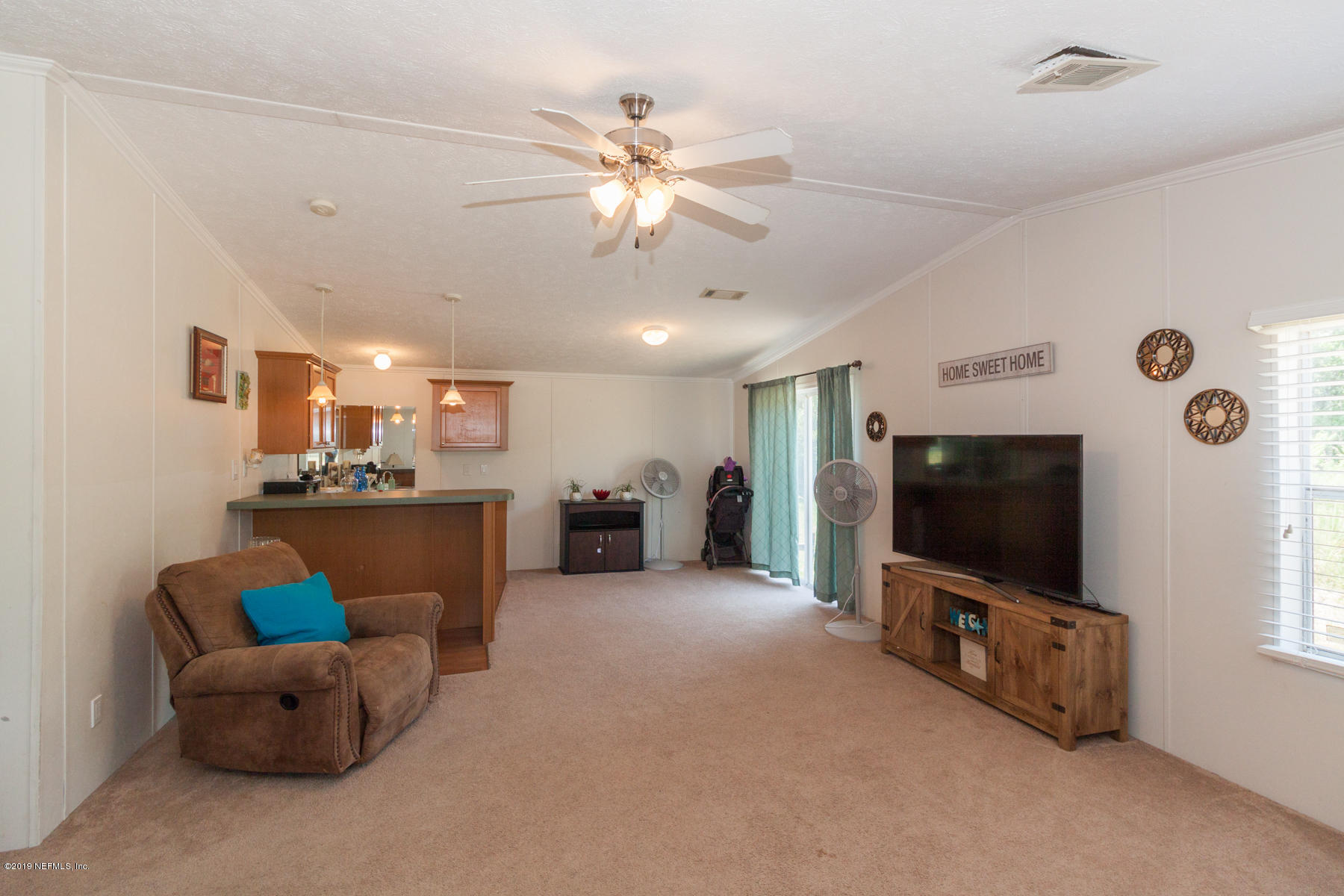 55154 Spencerville Road Callahan, FL 32011 - Photo 8 of 23 a living room with furniture and a flat screen tv