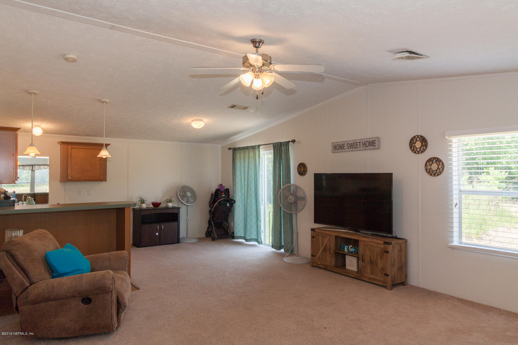 55154 Spencerville Road Callahan, FL 32011 - Photo 10 of 23 a living room with furniture and a flat screen tv
