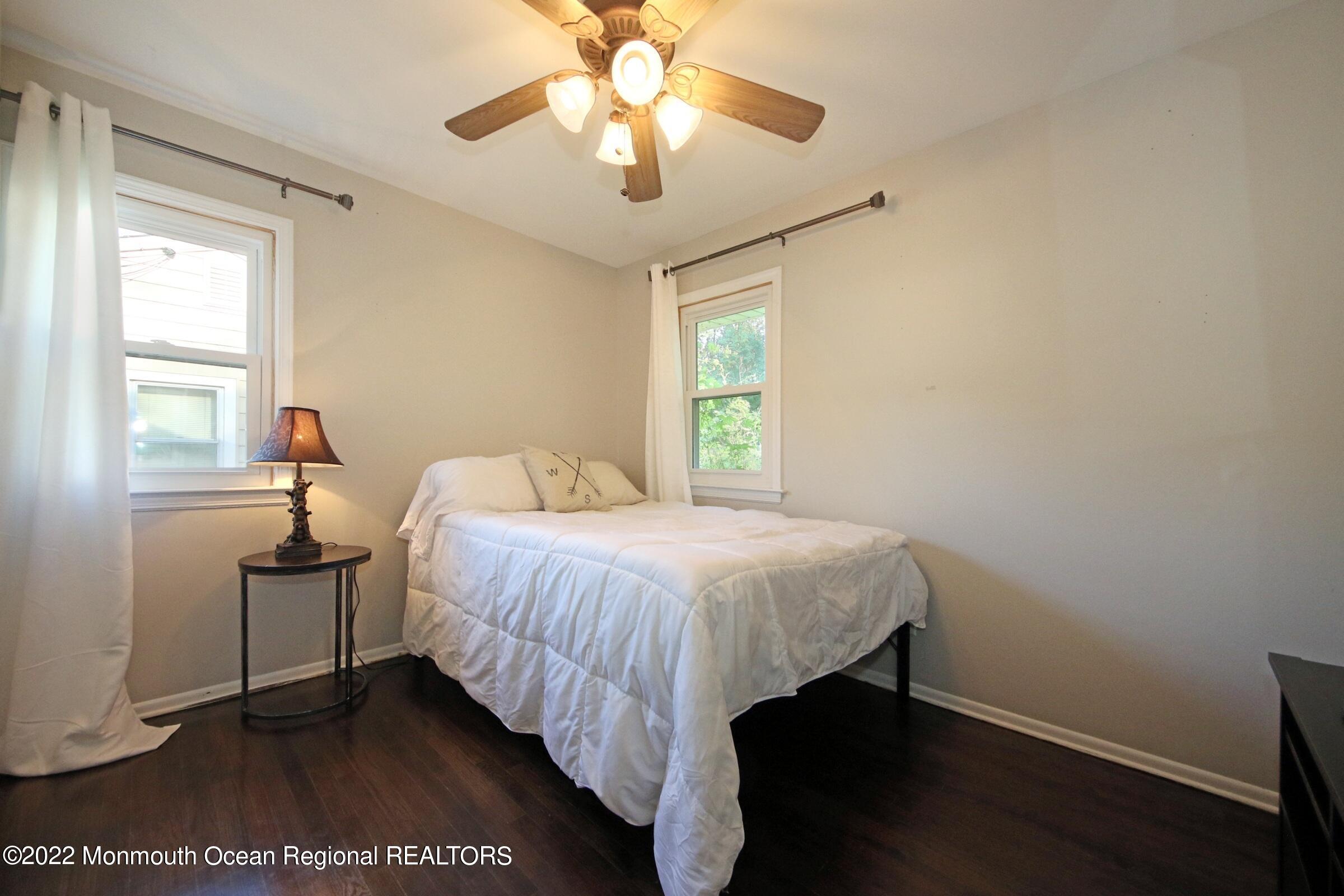 18 Crestview Drive Middletown, NJ 07748 - Photo 18 of 20 a bedroom with a bed and a chandelier