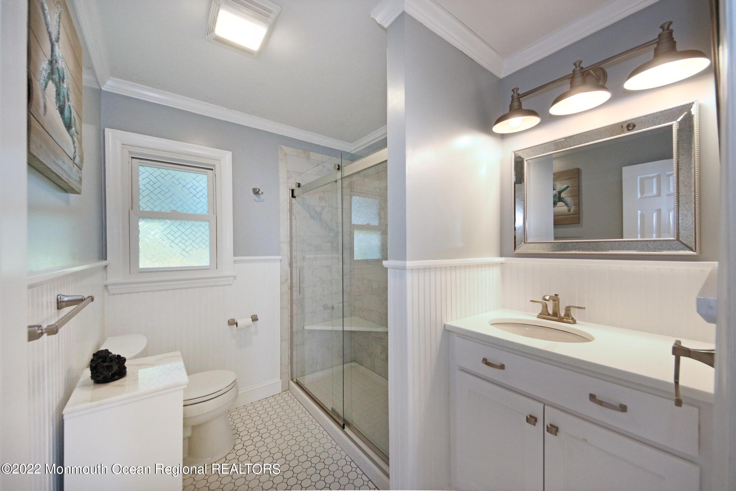 18 Crestview Drive Middletown, NJ 07748 - Photo 20 of 20 a bathroom with a sink a toilet and shower