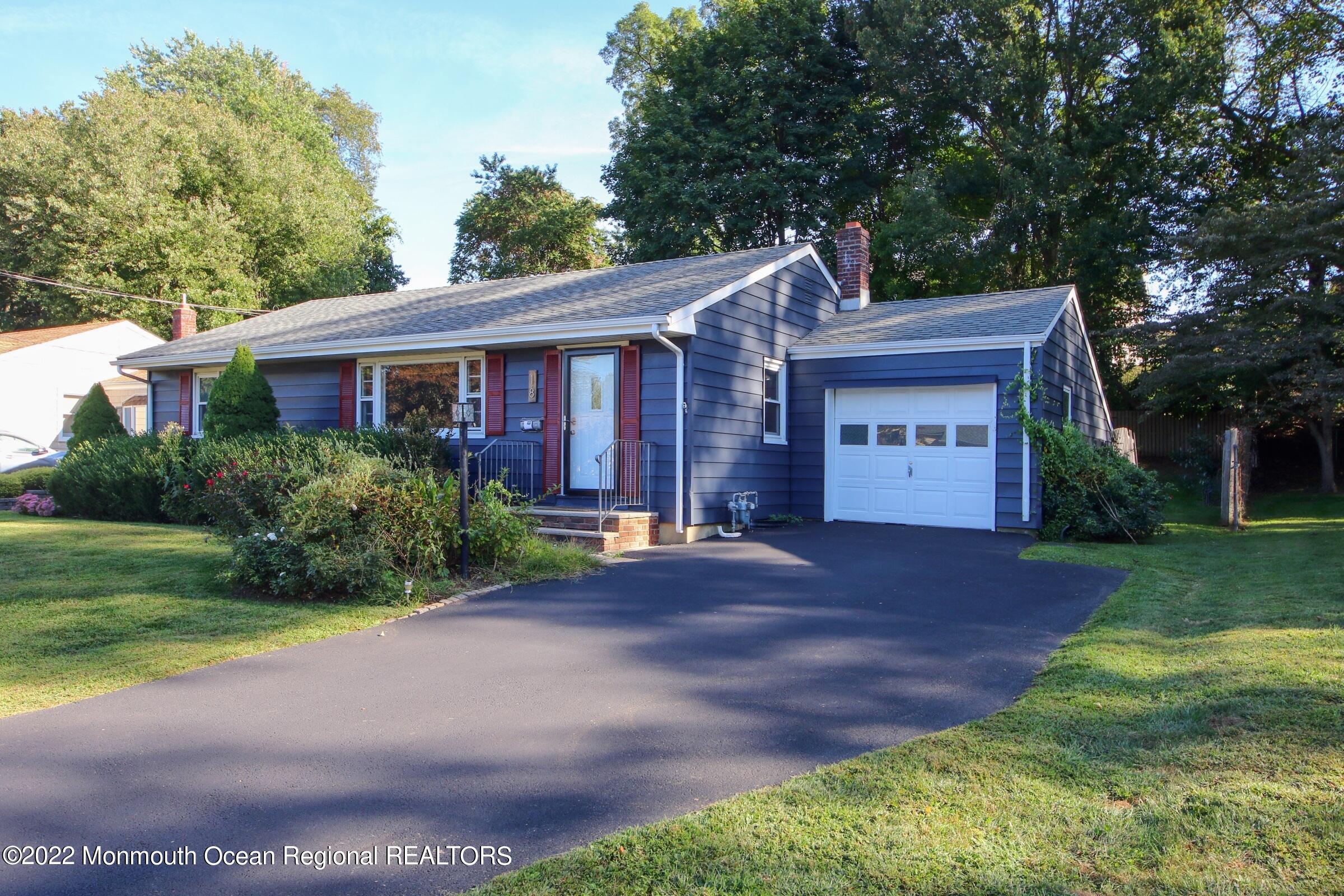 18 Crestview Drive Middletown, NJ 07748 - Photo 3 of 20 a front view of a house with a yard and garage