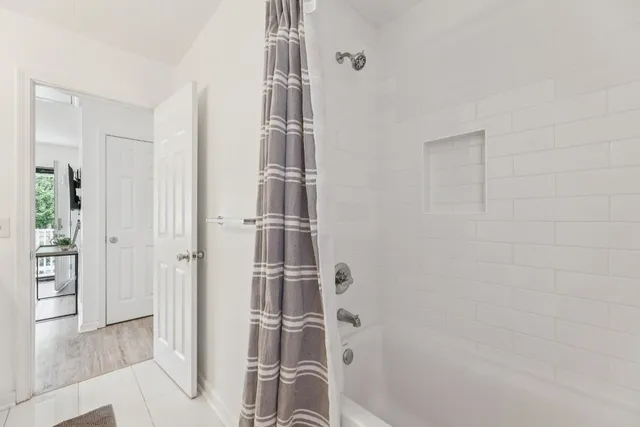 a bathroom with a shower and a glass door