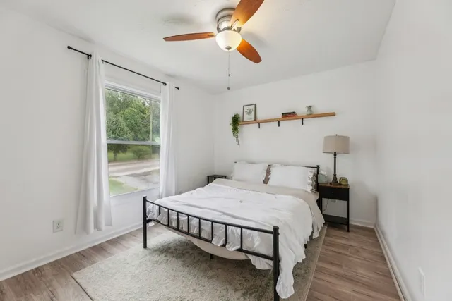 a bedroom with a bed and a chandelier