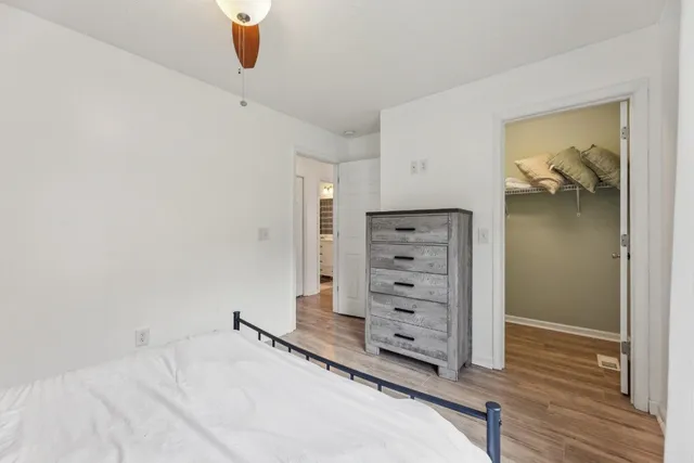 a view of a bedroom with wooden floor