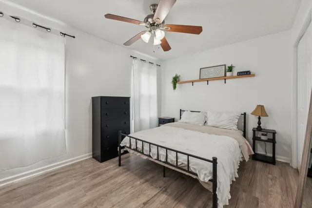 a bedroom with a bed and a chandelier