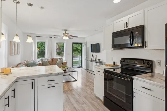 a kitchen with a sink stove and microwave