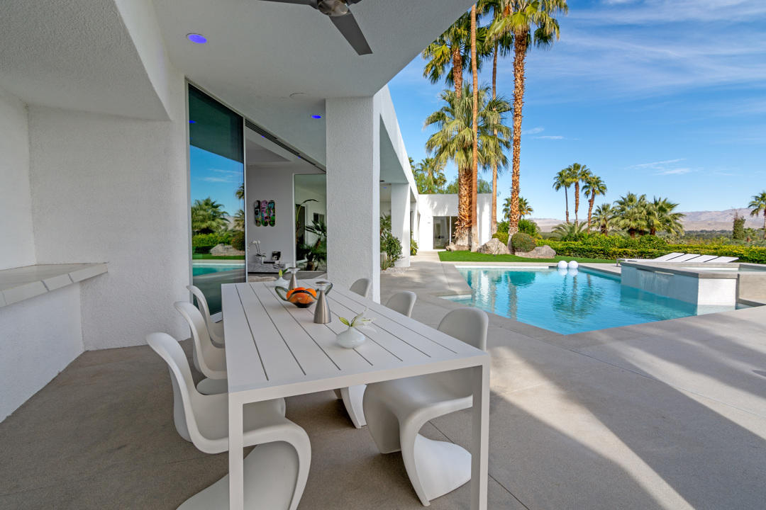 70288 Pecos Road Rancho Mirage, CA 92270 - Photo 12 of 76 a dining room with furniture and a kitchen view