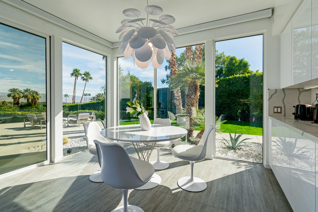 70288 Pecos Road Rancho Mirage, CA 92270 - Photo 27 of 76 a view of a dining room with furniture a chandelier and wooden floor