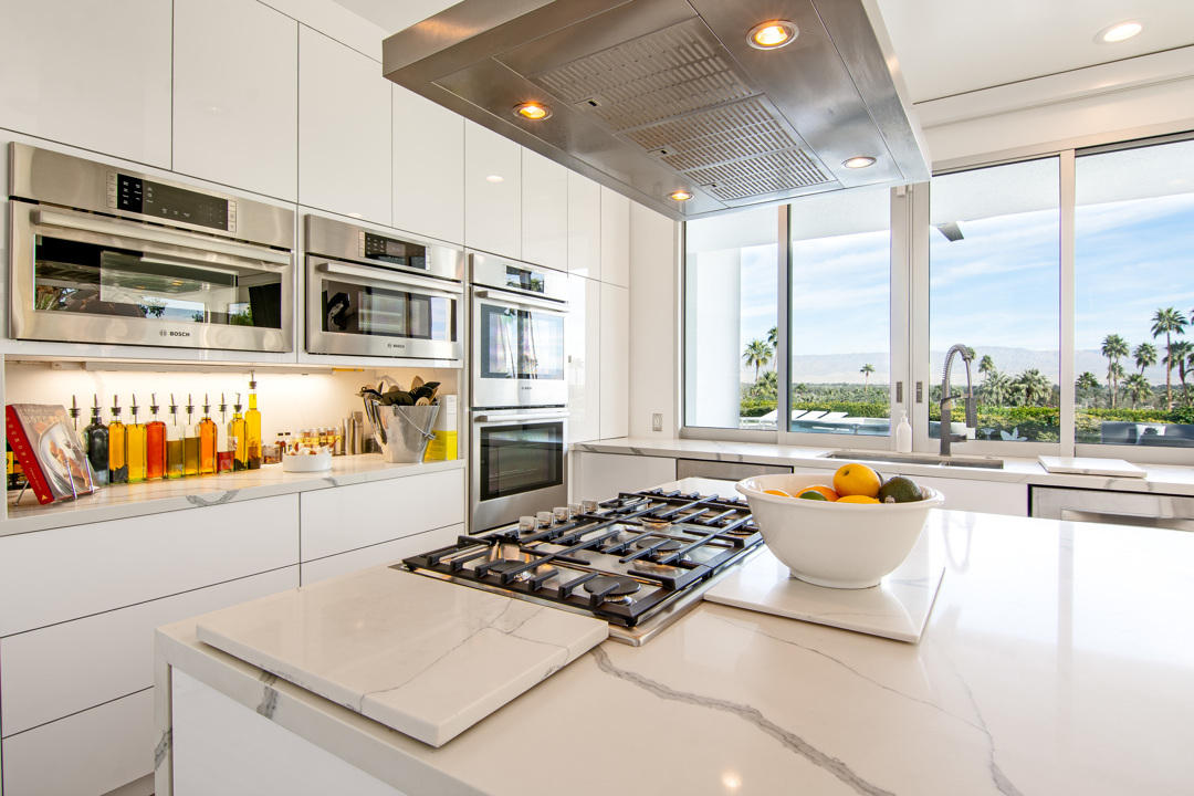 70288 Pecos Road Rancho Mirage, CA 92270 - Photo 29 of 76 a kitchen with stainless steel appliances granite countertop a stove and a refrigerator