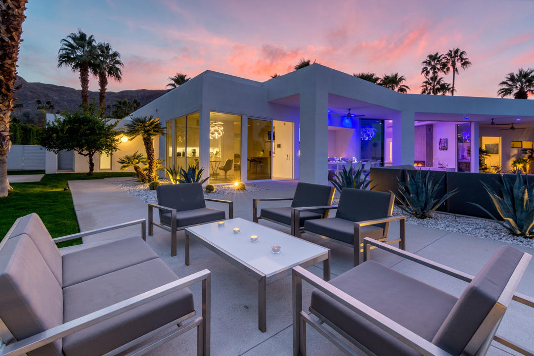 70288 Pecos Road Rancho Mirage, CA 92270 - Photo 73 of 76 a view of a patio with couches table and chairs under an umbrella with a fire pit