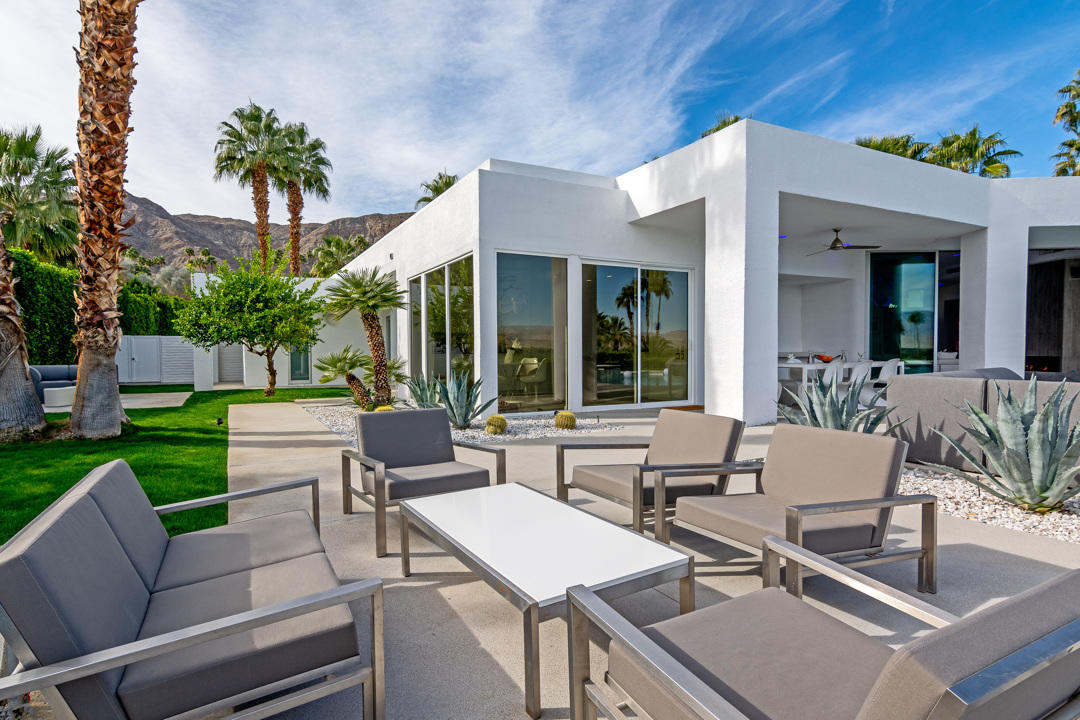 70288 Pecos Road Rancho Mirage, CA 92270 - Photo 9 of 76 a view of a patio with couches table and chairs with wooden fence and plants