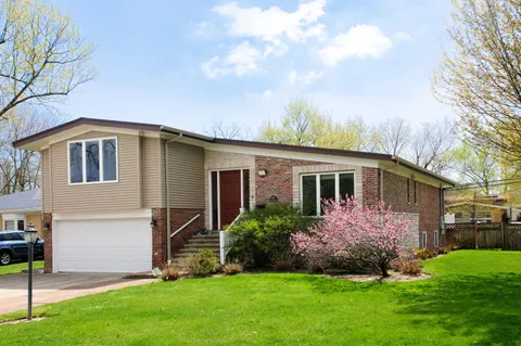 a front view of house with yard and green space