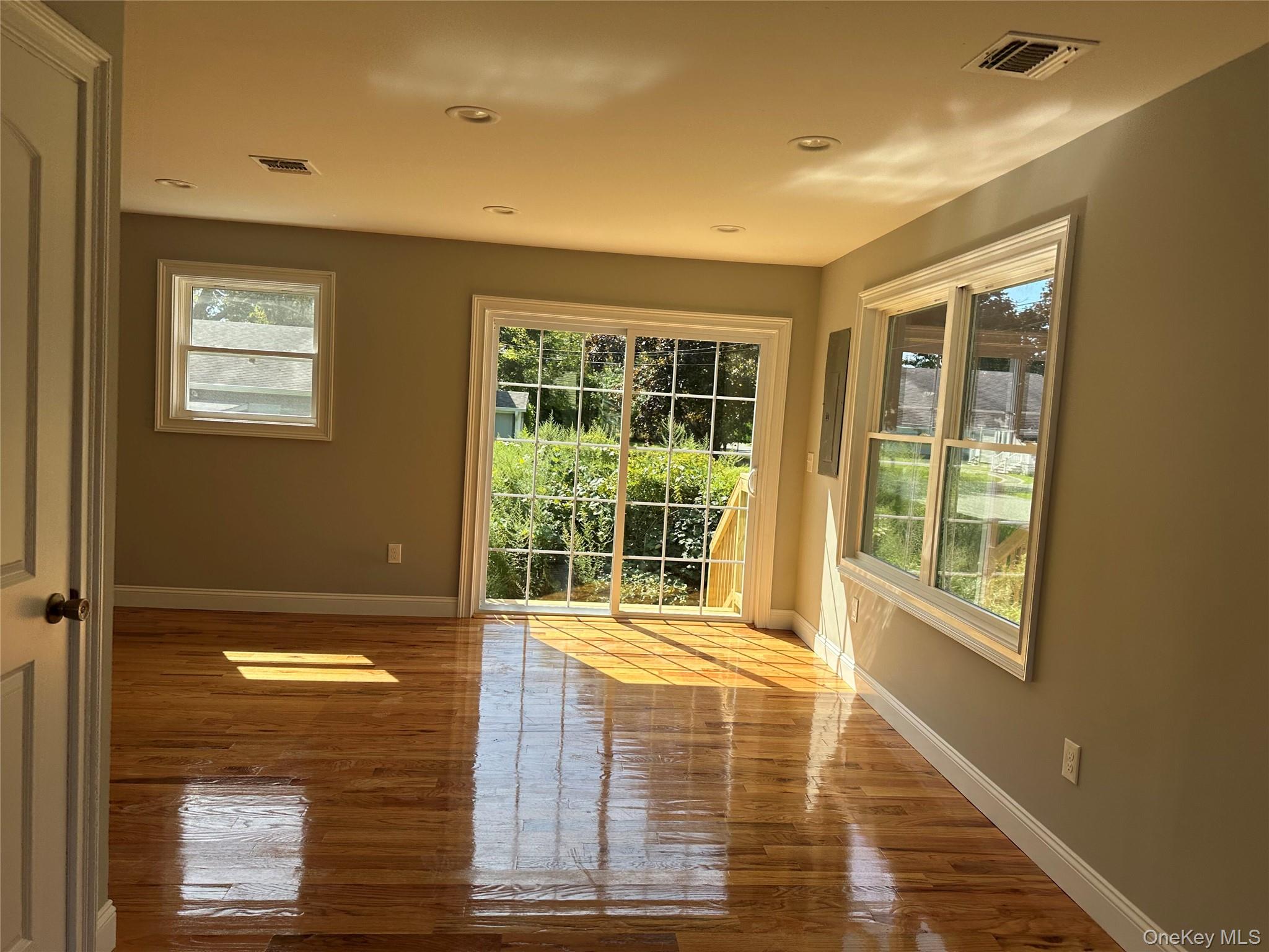214 Forest Road West Mastic Beach, NY 11951 - Photo 4 of 24 1st Floor Family Room featuring wood-finish flooring, recessed lighting, and light gray wall tones