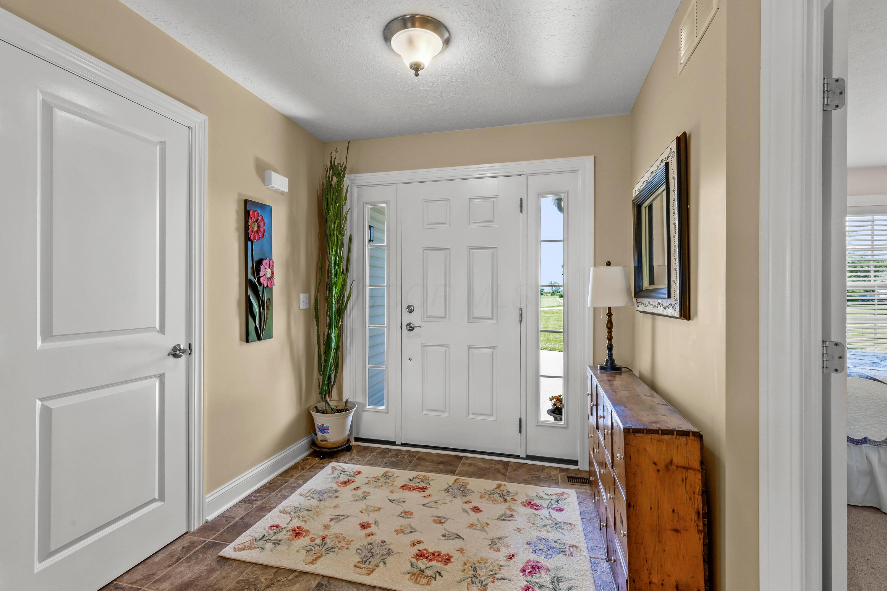 3582 Panhandle Road Delaware, OH 43015 - Photo 5 of 65 • Ceramic tile flooring • Vanilla painted walls • Ceiling light • Coat closet