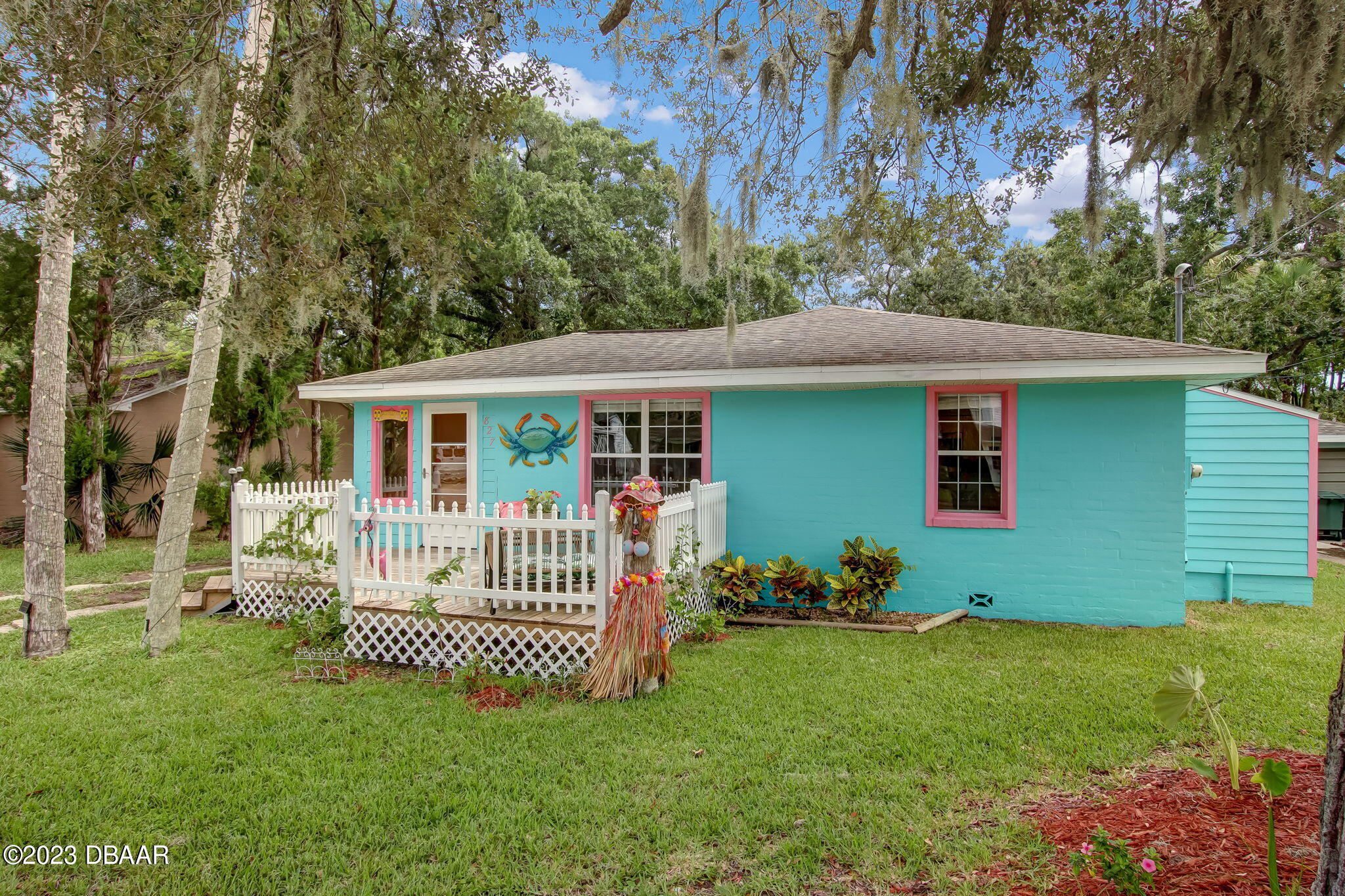 827 South Beach Street Daytona Beach, FL 32114 - Photo 1 of 40 a front view of a house with a garden