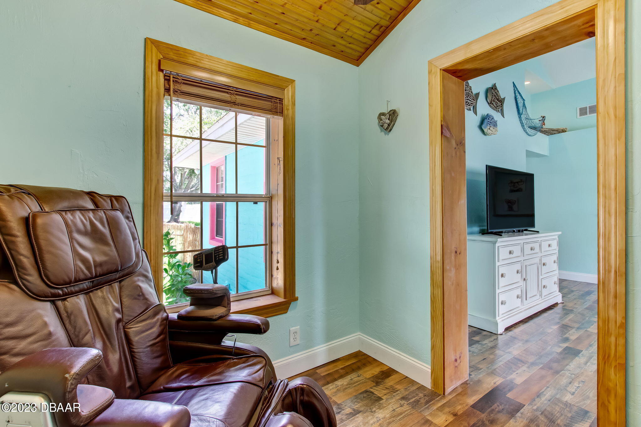 827 South Beach Street Daytona Beach, FL 32114 - Photo 11 of 40 a living room with furniture and a flat screen tv