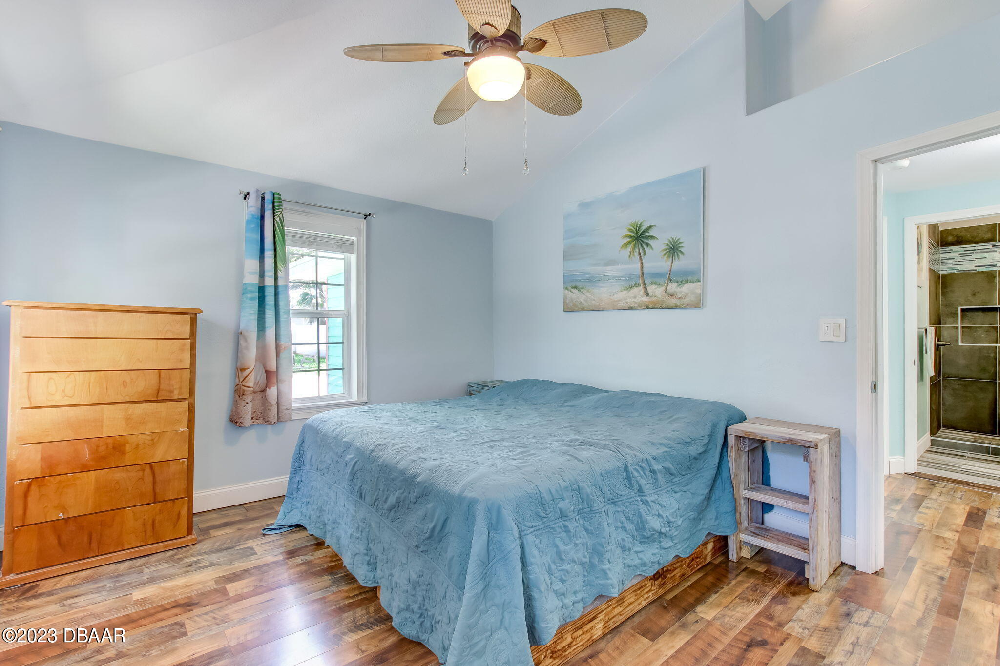 827 South Beach Street Daytona Beach, FL 32114 - Photo 21 of 40 a bedroom with a bed and a chandelier