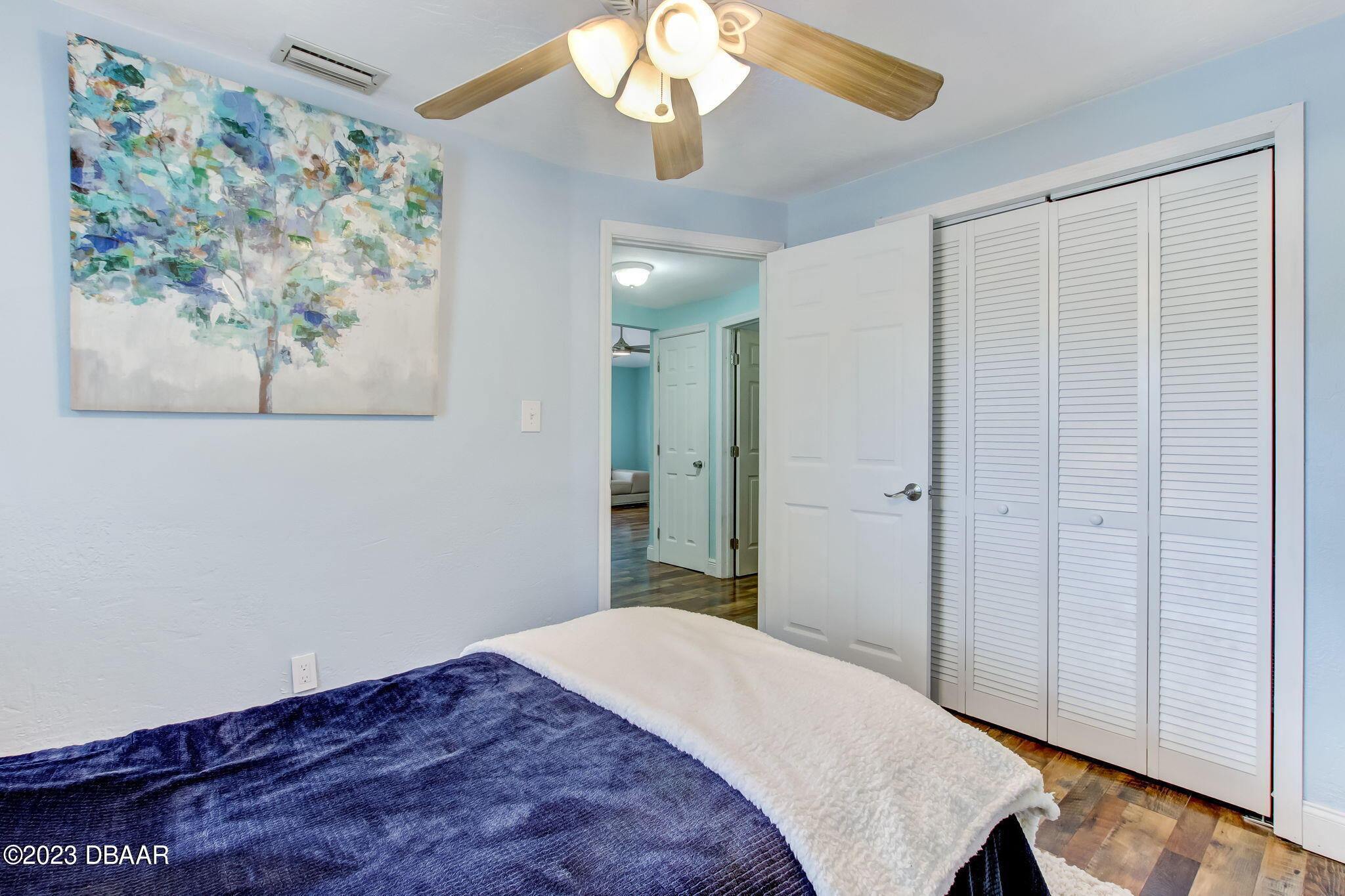 827 South Beach Street Daytona Beach, FL 32114 - Photo 24 of 40 a bedroom with a bed and a painting on the wall