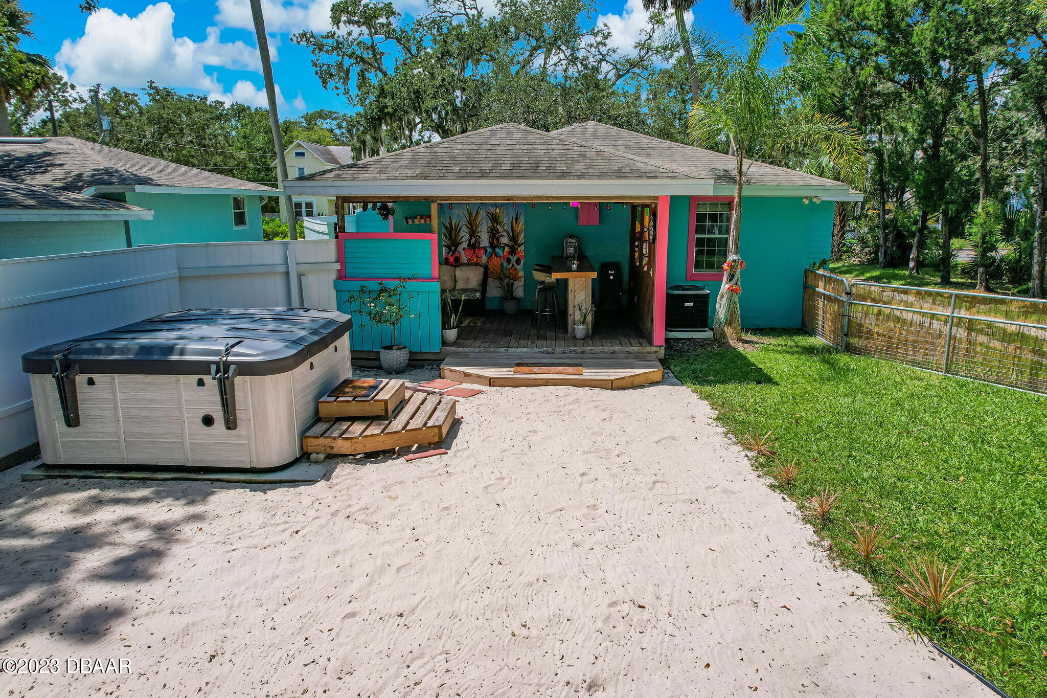 827 South Beach Street Daytona Beach, FL 32114 - Photo 38 of 40 a view of a patio with table and chairs under an umbrella