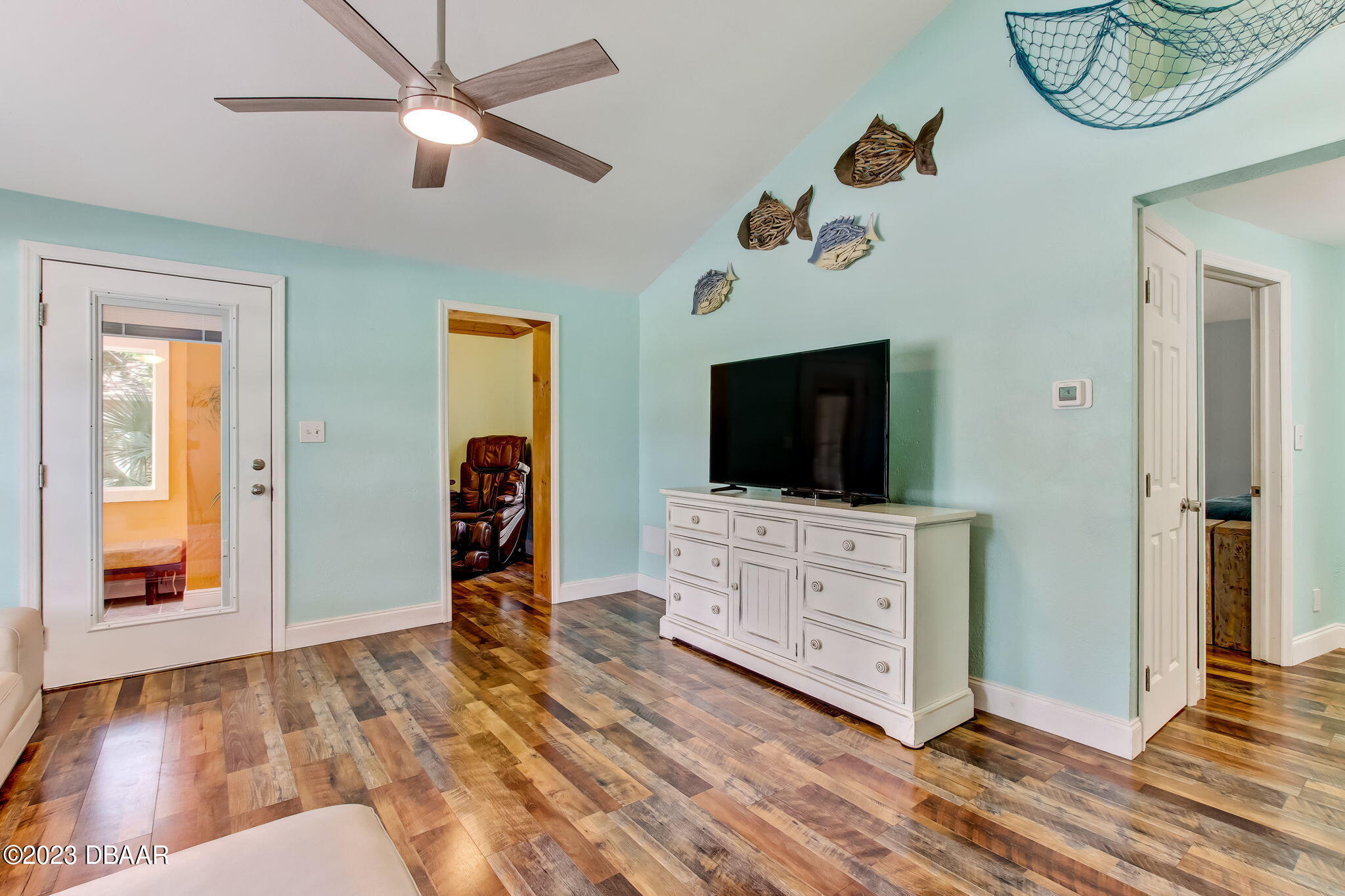 827 South Beach Street Daytona Beach, FL 32114 - Photo 9 of 40 a view of an livingroom with furniture wooden floor cabinet and a flat screen tv
