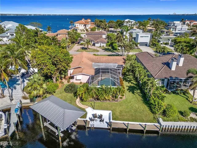 an aerial view of a house with a yard basket ball court and outdoor seating