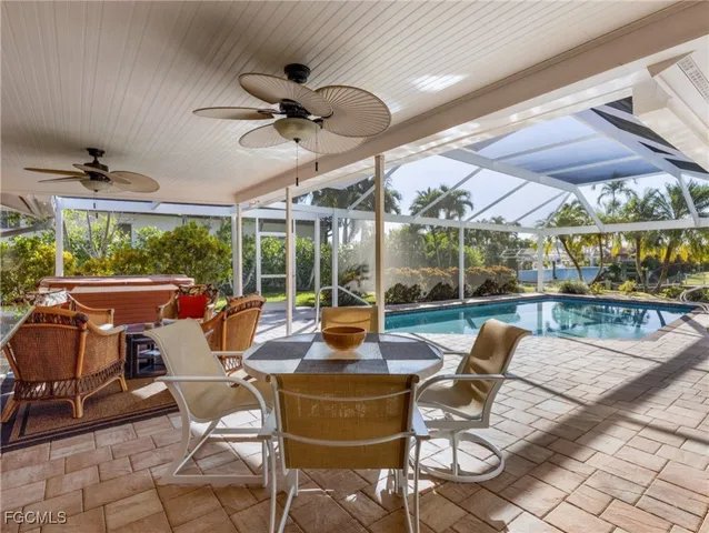 a view of a patio with a dining table and chairs