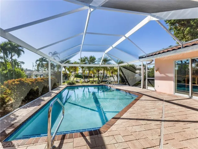 a view of a patio with table and chairs under an umbrella