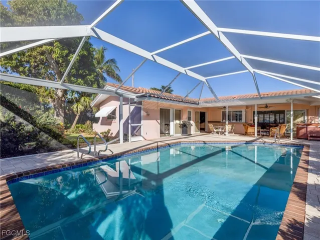 a view of a patio with table and chairs with wooden floor and fence