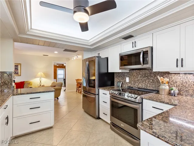 a kitchen with stainless steel appliances a stove microwave and cabinets