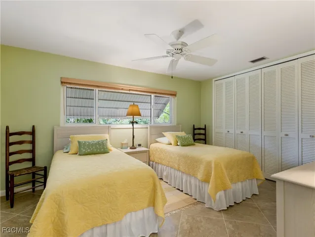 a bedroom with two beds and a chandelier