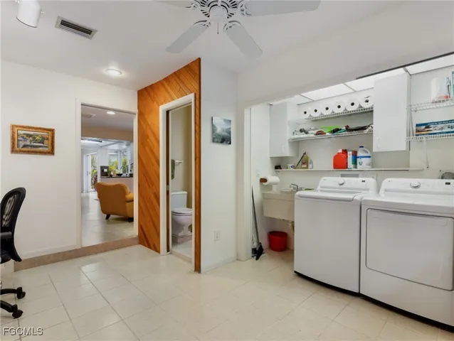 a utility room with cabinets dryer and washer