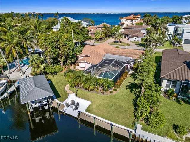 an aerial view of a house with a yard basket ball court and outdoor seating