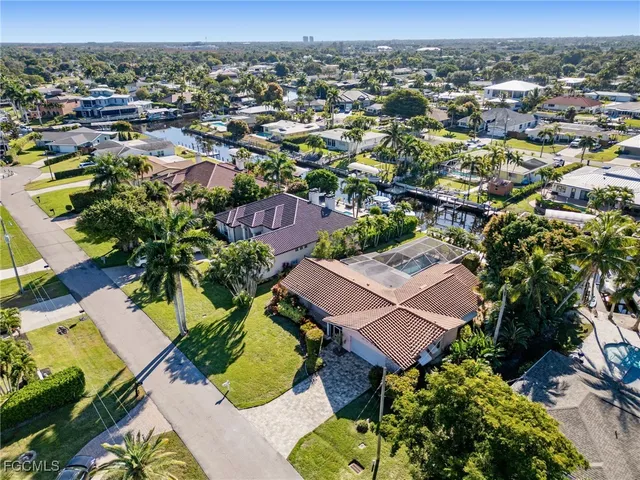 an aerial view of residential houses with outdoor space and parking
